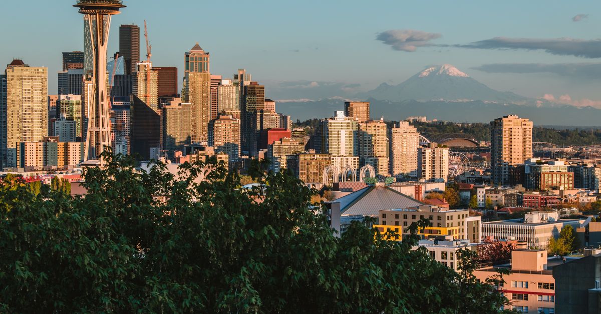 Stunning view of Seattle's iconic skyline featuring the Space Needle and Mount Rainier in the background.